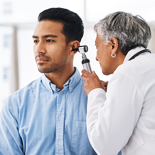 Man getting his ears checked to know what type of hearing loss he has